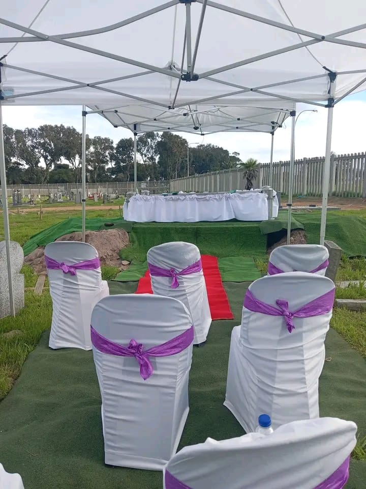 Elegant White Chairs with Purple Sashes Under Canopy
